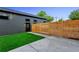 Backyard with a privacy fence, a patch of green grass, and a concrete patio at 2376 S Bannock St, Denver, CO 80223