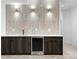 Wet bar area with stainless steel beverage fridge, designer backsplash and modern lighting at 2376 S Bannock St, Denver, CO 80223