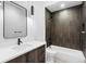 Modern bathroom featuring a vanity, toilet and bathtub with a dark tiled shower surround at 2376 S Bannock St, Denver, CO 80223