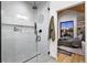 Contemporary bathroom with a glass shower and glimpse of the bedroom at 2376 S Bannock St, Denver, CO 80223