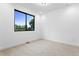 Bright bedroom features a large window offering plenty of natural light and neutral decor at 2376 S Bannock St, Denver, CO 80223