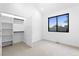 Bedroom with plush carpet, a window letting in natural light and an open closet at 2376 S Bannock St, Denver, CO 80223