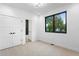 Bedroom featuring neutral carpet, large window and access to a bathroom at 2376 S Bannock St, Denver, CO 80223