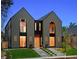 A modern home featuring a grey exterior, large windows with black trim, and landscaped front yard at 2376 S Bannock St, Denver, CO 80223
