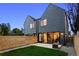 Stunning modern home with a fenced yard, patio, and ample natural light through large sliding glass doors at 2376 S Bannock St, Denver, CO 80223