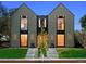 Modern home showcasing a gray exterior, expansive windows with black trim, and a well-kept front yard at 2376 S Bannock St, Denver, CO 80223