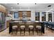 Spacious kitchen featuring a large island with barstool seating, modern appliances, and hardwood floors at 2376 S Bannock St, Denver, CO 80223