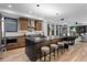 Modern kitchen with stainless steel appliances, dark countertops, and a spacious island with seating at 2376 S Bannock St, Denver, CO 80223