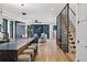 Open concept living space featuring a modern kitchen, black staircase, and a bright and airy atmosphere at 2376 S Bannock St, Denver, CO 80223