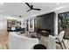 Spacious living room with a fireplace, modern furniture, and an open view to the kitchen and dining area at 2376 S Bannock St, Denver, CO 80223