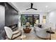 Bright living room featuring a sleek fireplace, stylish furniture, and sliding glass doors to the backyard at 2376 S Bannock St, Denver, CO 80223