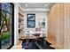 Stylish home office with wood paneled wall, modern desk, and ample natural light at 2376 S Bannock St, Denver, CO 80223
