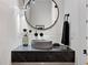 Modern powder room with a vessel sink, unique mirror, and contemporary fixtures at 2376 S Bannock St, Denver, CO 80223