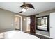 Comfortable bedroom showcasing a modern ceiling fan, hardwood floors, and a barn-door leading to bathroom at 742 Yank St, Lakewood, CO 80401