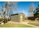 Exterior view of a well maintained shed with wooden door, nestled in a landscaped backyard setting at 742 Yank St, Lakewood, CO 80401