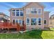 Beautiful backyard featuring mature trees, and a well-maintained lawn, with a deck at 5017 Bella Vista Dr, Longmont, CO 80503