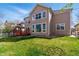 Large backyard with lush green grass and mature trees surrounding the property at 5017 Bella Vista Dr, Longmont, CO 80503