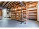 Unfinished basement with exposed wood beams and shelving for storage at 5017 Bella Vista Dr, Longmont, CO 80503