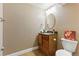 Stylish bathroom featuring a decorative framed mirror, under-sink storage, and a granite countertop at 5017 Bella Vista Dr, Longmont, CO 80503