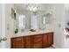 Bathroom with double vanity, large mirror, and plenty of cabinet space at 5017 Bella Vista Dr, Longmont, CO 80503