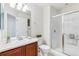 Bright bathroom featuring a vanity, toilet, and glass-enclosed shower at 5017 Bella Vista Dr, Longmont, CO 80503