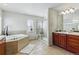 Bathroom with soaking tub, large walk-in shower, and double sink vanity at 5017 Bella Vista Dr, Longmont, CO 80503