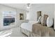 Bright bedroom with large window, ceiling fan, and neutral decor at 5017 Bella Vista Dr, Longmont, CO 80503