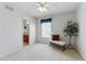 Bedroom featuring neutral carpet, a decorative bench, and an ensuite bathroom at 5017 Bella Vista Dr, Longmont, CO 80503