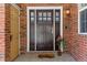 Elegant front door with sidelights and a welcoming 'home' doormat at 5017 Bella Vista Dr, Longmont, CO 80503