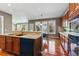 The kitchen area offers a large kitchen island, modern appliances and dark hardwood floors at 5017 Bella Vista Dr, Longmont, CO 80503