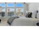 Bedroom features decorative pillows and luxurious bed coverings under large bright windows at 5017 Bella Vista Dr, Longmont, CO 80503
