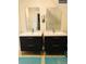 Modern bathroom featuring dual vanity sinks with black cabinets and tiled flooring at 4428 Perry St, Denver, CO 80212