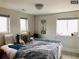 Comfortable bedroom featuring bright windows, a cozy bed, and unique decor at 4428 Perry St, Denver, CO 80212