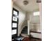 Inviting entryway features wood floors, a staircase with white accents, and a stylish front door at 4428 Perry St, Denver, CO 80212