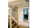Hallway view showcases stairs with carpet runner and open door to bathroom at 4428 Perry St, Denver, CO 80212
