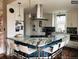 Modern kitchen boasts white cabinets, a marble-top island with seating, and stainless steel appliances at 4428 Perry St, Denver, CO 80212