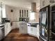 Bright kitchen with white cabinets, stainless appliances, and wood floors, ideal for cooking at 4428 Perry St, Denver, CO 80212