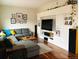 Cozy living room with a gray sectional, wooden floors, and a large entertainment center at 4428 Perry St, Denver, CO 80212