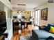 Open-concept living and kitchen area with hardwood floors and modern pendant lighting at 4428 Perry St, Denver, CO 80212