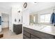 Bathroom with double sinks, large mirror, and tiled floors at 720 Remington Dr, Hudson, CO 80642