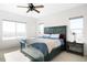 Bedroom with rustic bed frame, light colored carpet, and bright natural light at 720 Remington Dr, Hudson, CO 80642