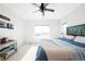 This bedroom features a ceiling fan, neutral walls, and a large window at 720 Remington Dr, Hudson, CO 80642