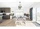 Open dining area adjacent to the kitchen features a modern table, stylish chairs, and lots of natural light at 720 Remington Dr, Hudson, CO 80642