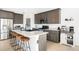 Well-lit kitchen featuring a large island with seating and lots of countertop space at 720 Remington Dr, Hudson, CO 80642