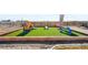 Backyard playground with colorful play structures, nestled on a grassy area at 720 Remington Dr, Hudson, CO 80642