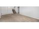 Carpeted basement featuring a stairway to the main floor and shelving units at 387 Tucson St, Aurora, CO 80011