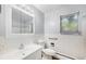 Clean bathroom featuring a vanity, toilet, accessible handrail, and tiled walls at 387 Tucson St, Aurora, CO 80011