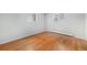 Bedroom features hardwood floors, light gray paint, and updated windows at 387 Tucson St, Aurora, CO 80011