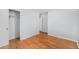 Bright bedroom features hardwood floors, closet and fresh light gray paint at 387 Tucson St, Aurora, CO 80011