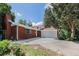 Charming brick home features a two-car garage, beautiful flowers and mature trees at 387 Tucson St, Aurora, CO 80011